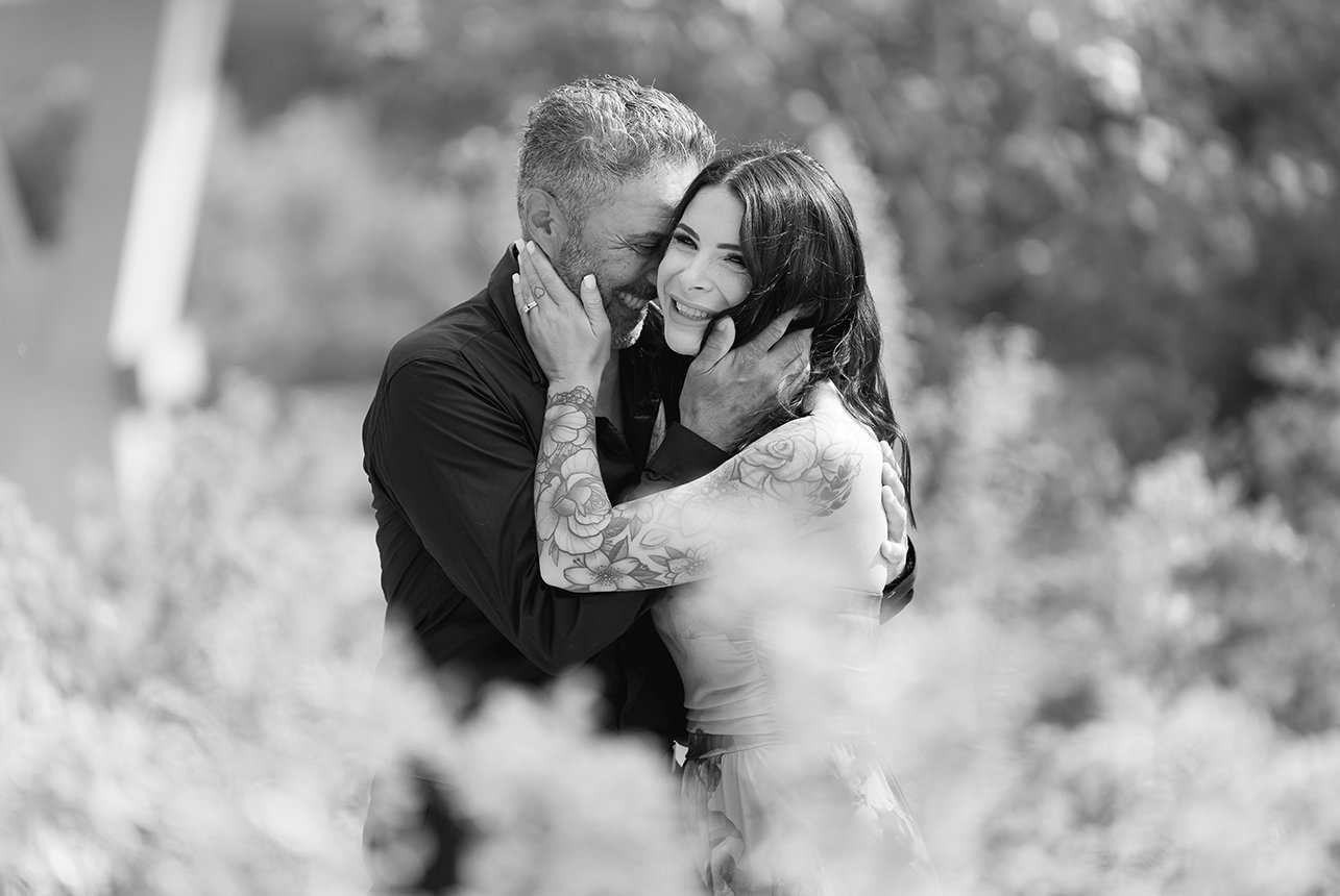Black and white photo of couple embracing in nature
