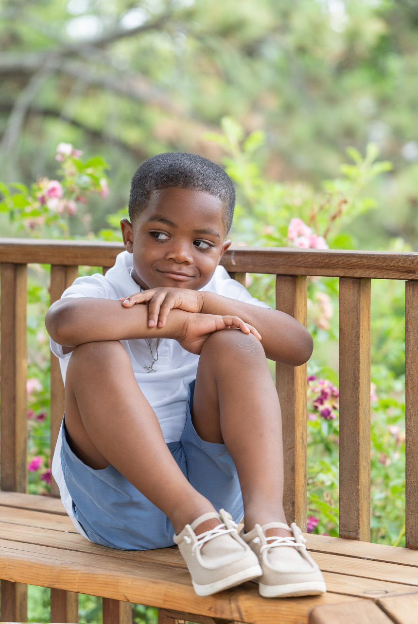 Young boy sitting at gazebo at Smeltzer House garden