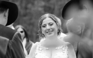 Bride holding back tears during vows at outdoor western-style Sherwood Park wedding