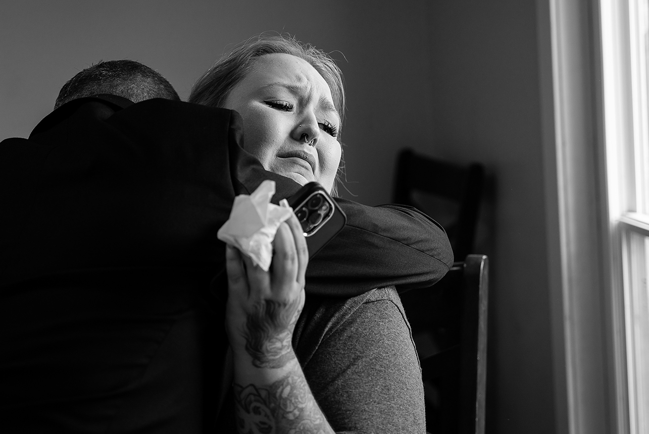 Bride in tears embracing her father before getting ready for the wedding, captured in a heartfelt moment at home