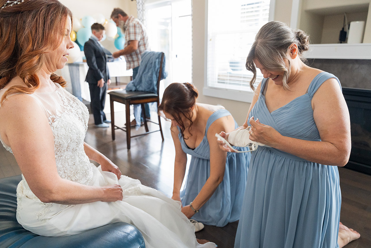Bride getting ready with bridesmaids and family in Spruce Grove home
