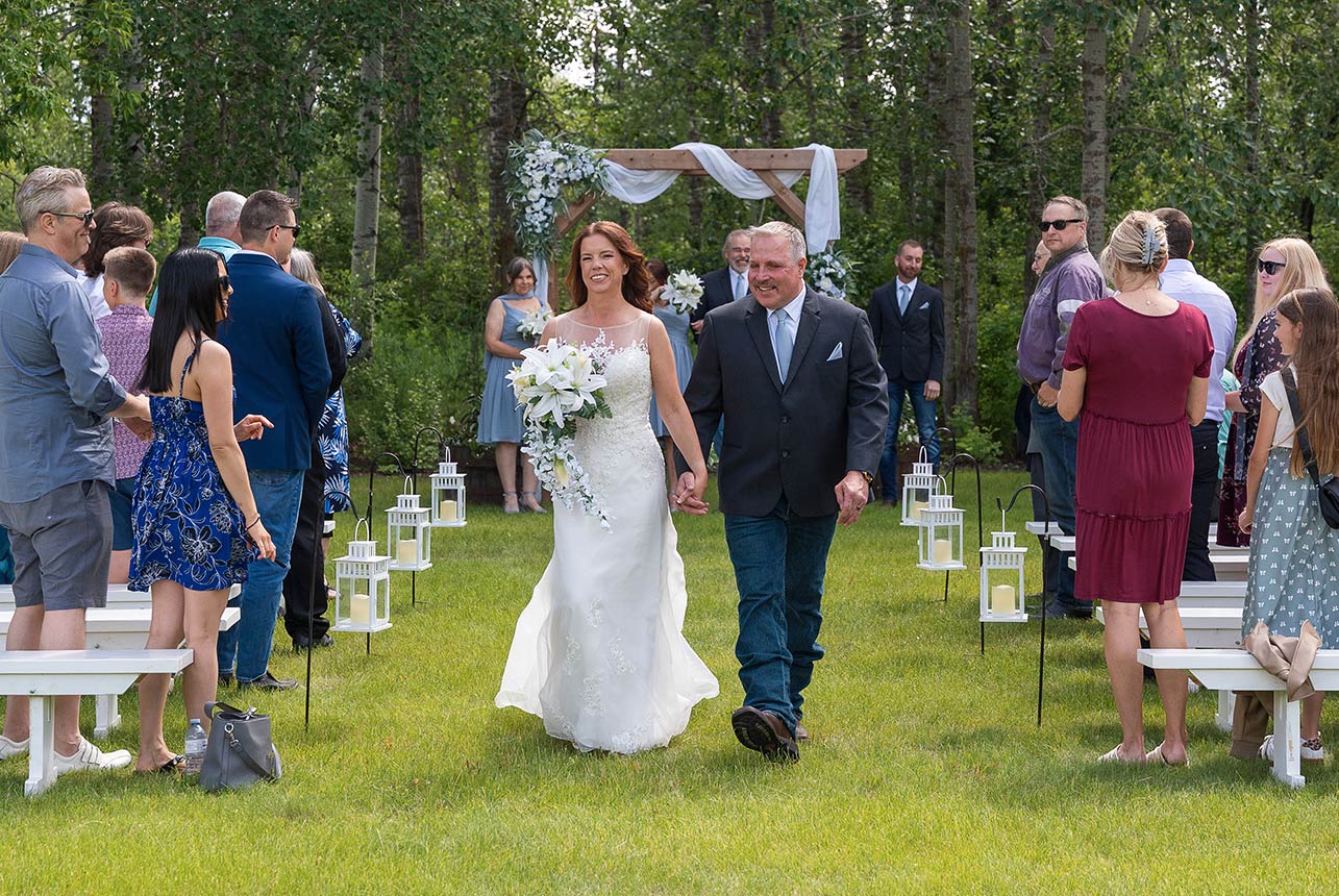 Bride and groom walking down the aisle after outdoor wedding ceremony