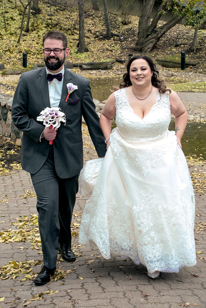 Couple-running-in-wedding-gear-Edmonton
