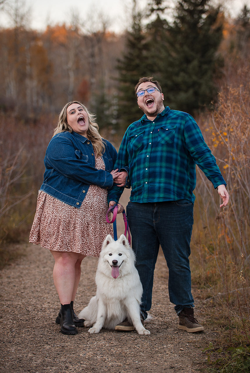 Couple with their dog, relaxed and comfortable during a photo shoot in the park