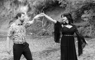 Emily and Gary dance by the creek during their Mill Creek engagement session with Catriona Hope Photography in Edmonton
