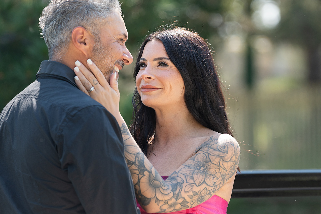 Woman smiles lovingly at her fiancé during golden hour in Edmonton