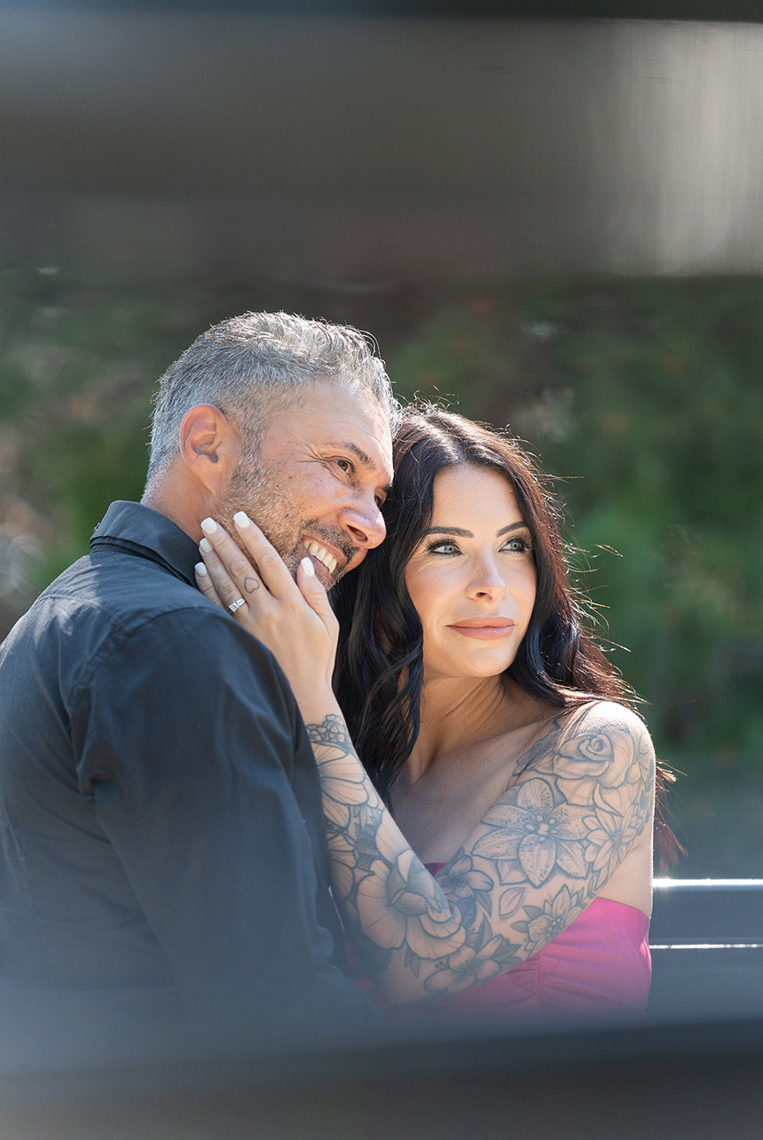 Engagement ring glistening as couple smiles in Edmonton park