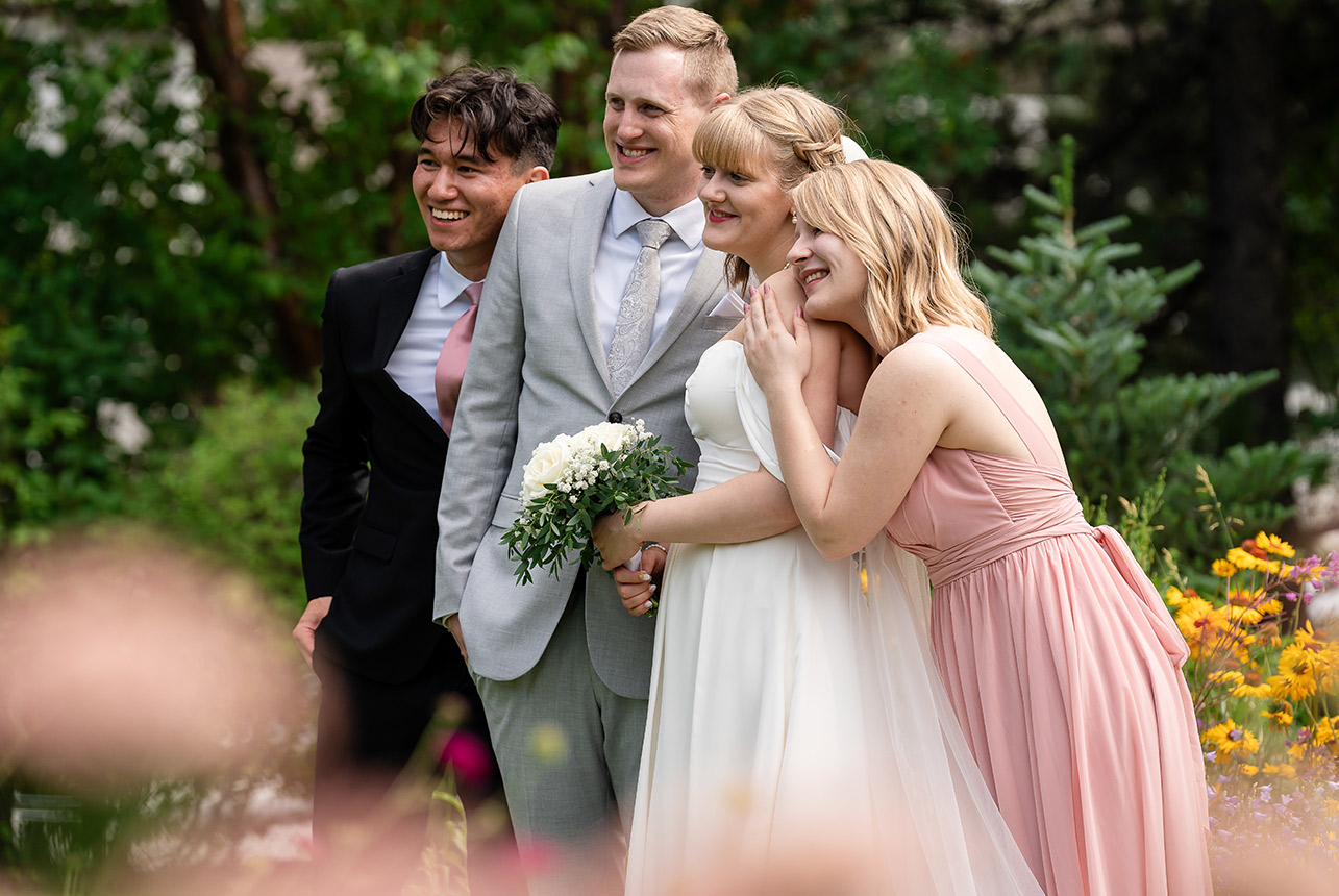 Bride and groom smiling with their bridal party in the church after the ceremony