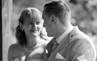 Bride and groom sharing an emotional moment in black and white under soft natural light