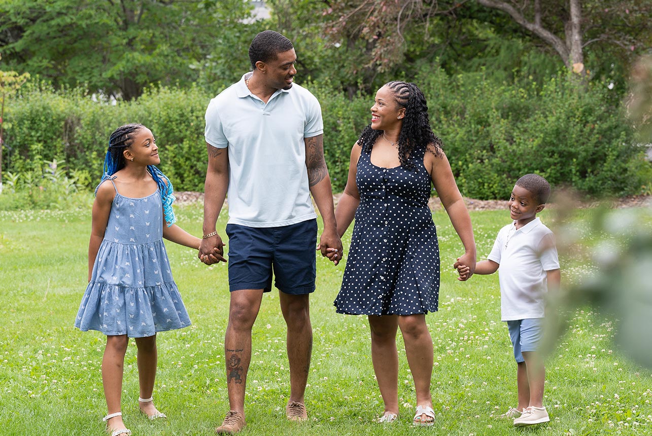 Family walking hand in hand at Smeltzer House in Sherwood Park