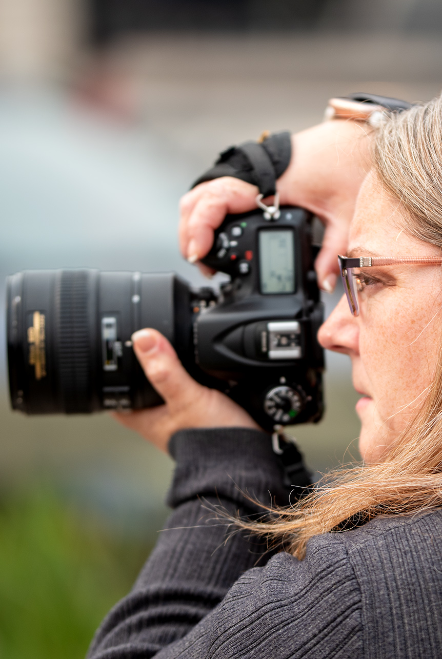 Focused Vision: Catriona’s Lens on the World Catriona, camera in hand, captures the essence of her subject with intense focus and artistic dedication.