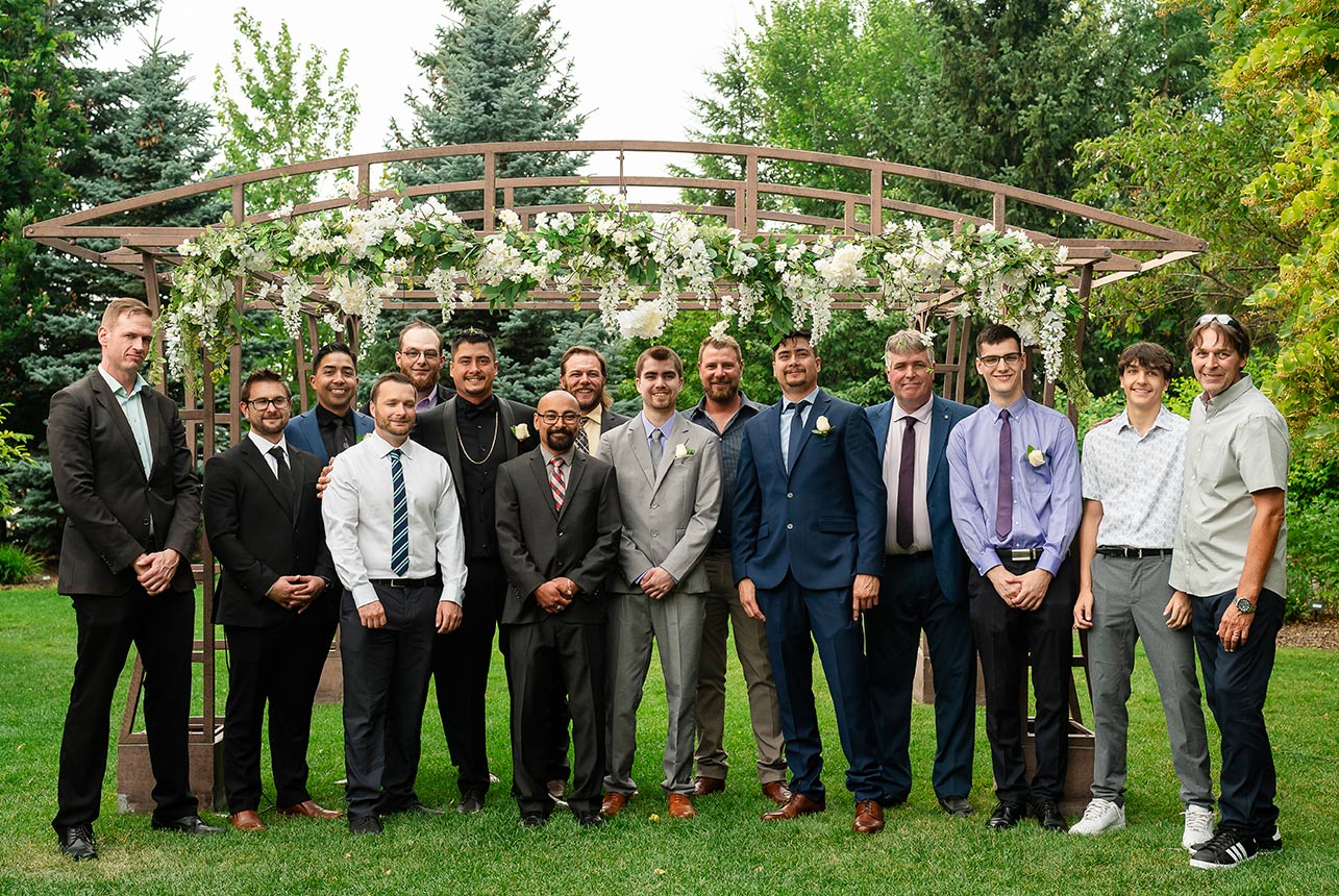 Groom surrounded by his groomsmen, celebrating his wedding day with friends and family in attendance.