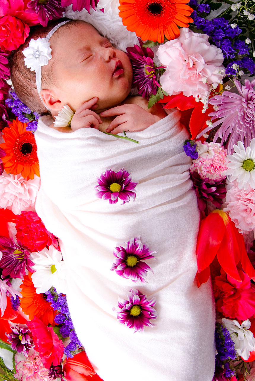 Pure Innocence Wrapped in White - Newborn Photography with Colorful Floral Accents
