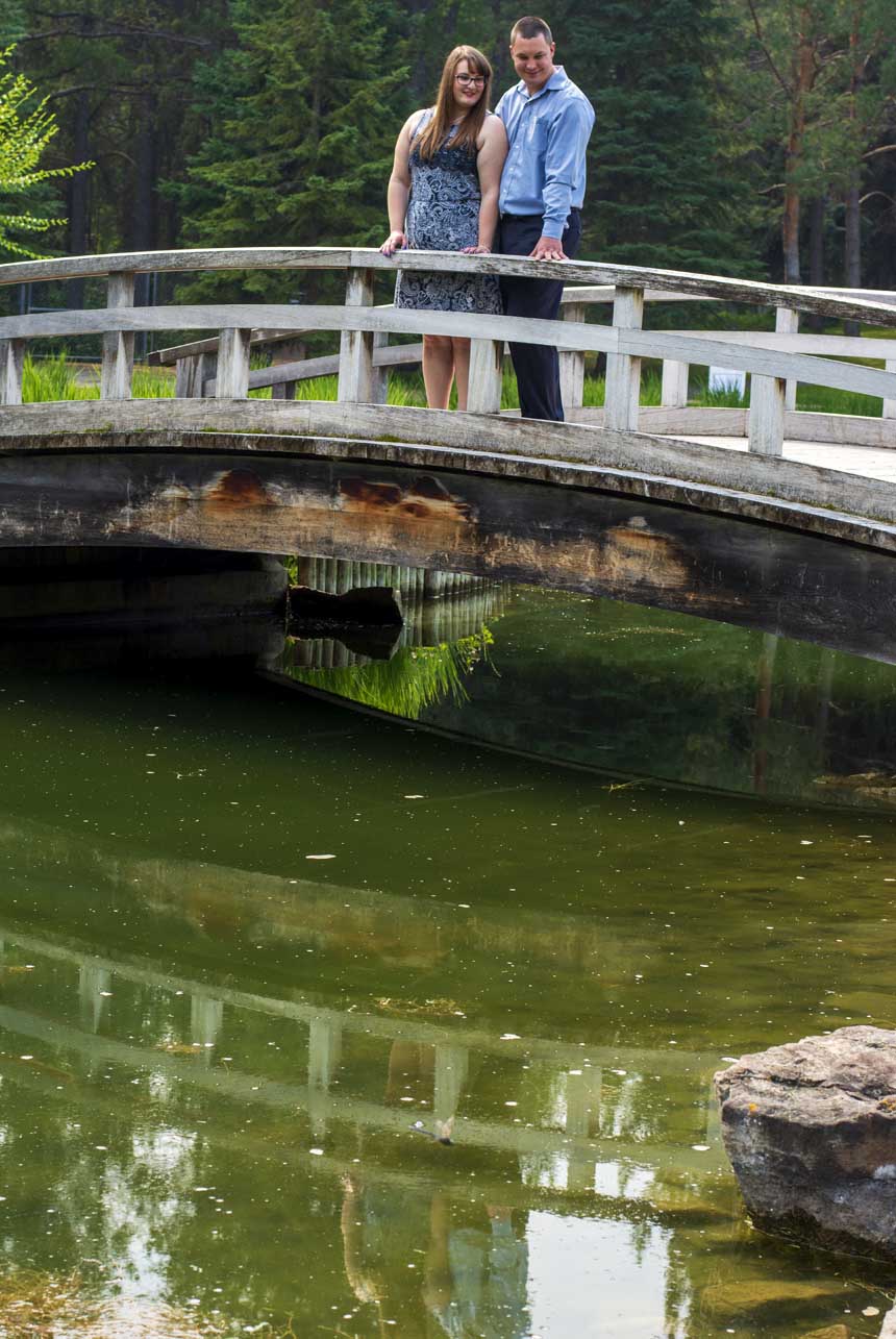 Newly engaged couple on water bridge green water Devon AB