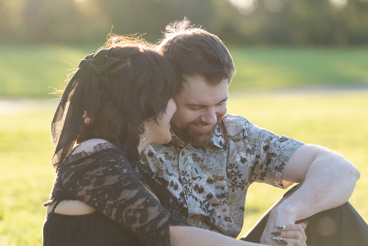 couple-sitting-grass-golden-hour-engagement-edmonton