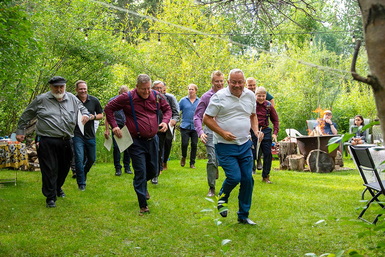 Wedding guests playing lawn games outdoors under string lights