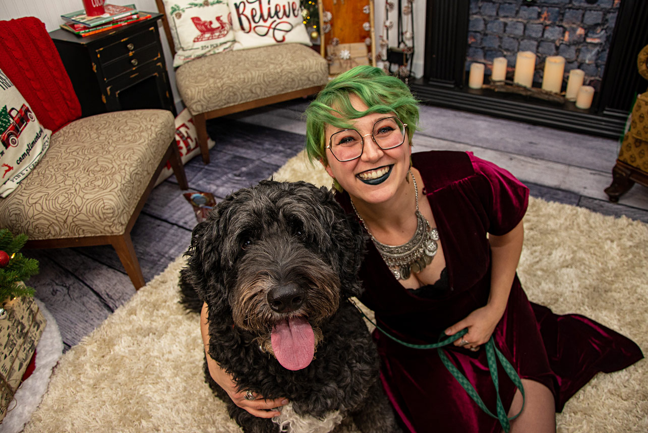 Woman-in-purple-dress-with-dog-during-Christmas